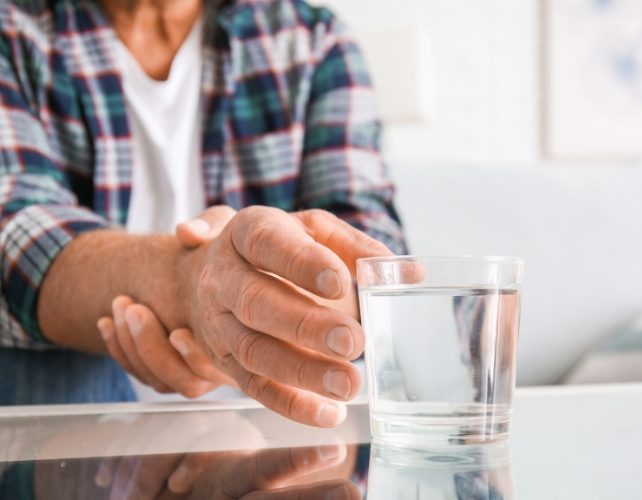 Hands picking up a glass