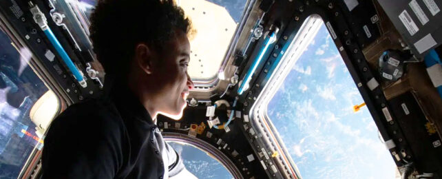 astronaut viewing earth from space station