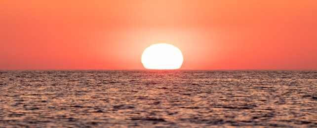 sun setting over an ocean
