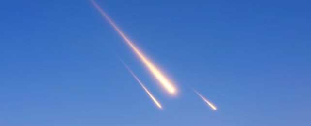 Three meteors in a blue sky