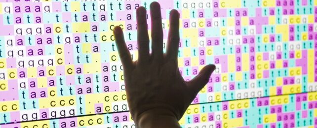 Hand Touches DNA Code On Screen