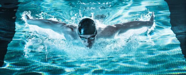 A swimmer in bright blue light