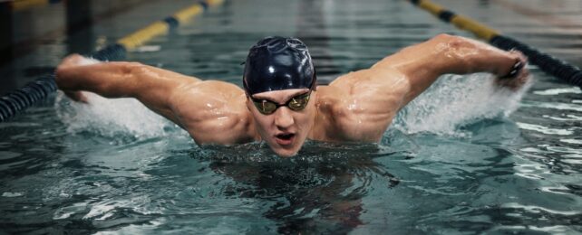 A male swimmer in an Olympic pool