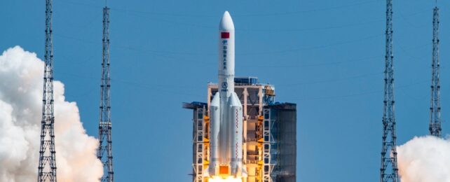 A rocket launching against a blue sky