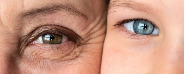 The eye of an older person on the left next to a young child's eye on the right