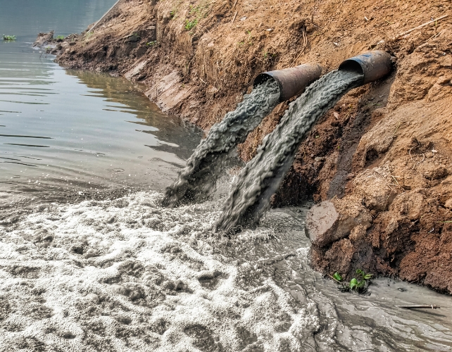 Dirty wastewater draining into a river