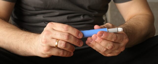 Man holding injector device