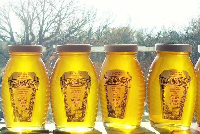 sunlit jars of honey in a window