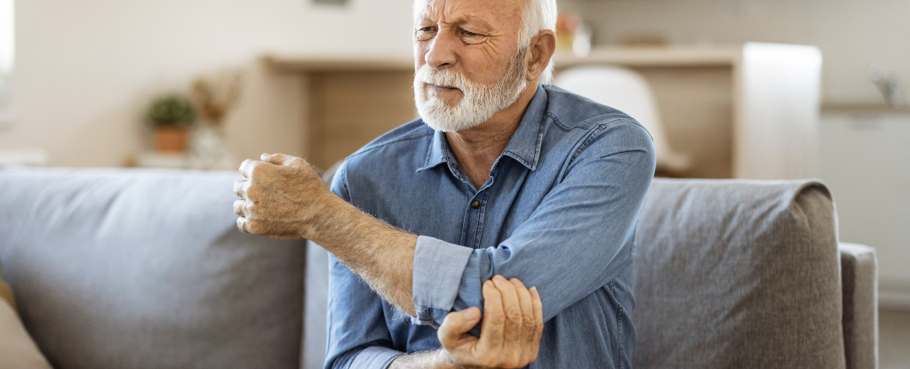 man holding elbow