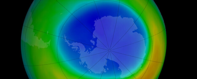 Blue hole over a map of Antarctica.