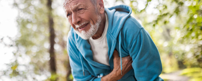 man clutching chest