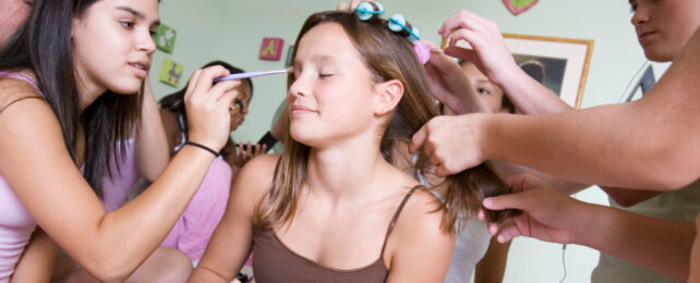 Girls at a slumber party doing makeup