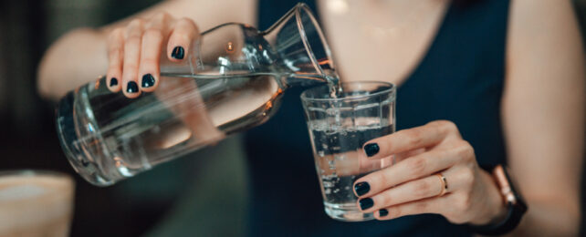 person pouring still water