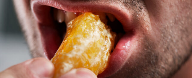 Person eating a mandarin