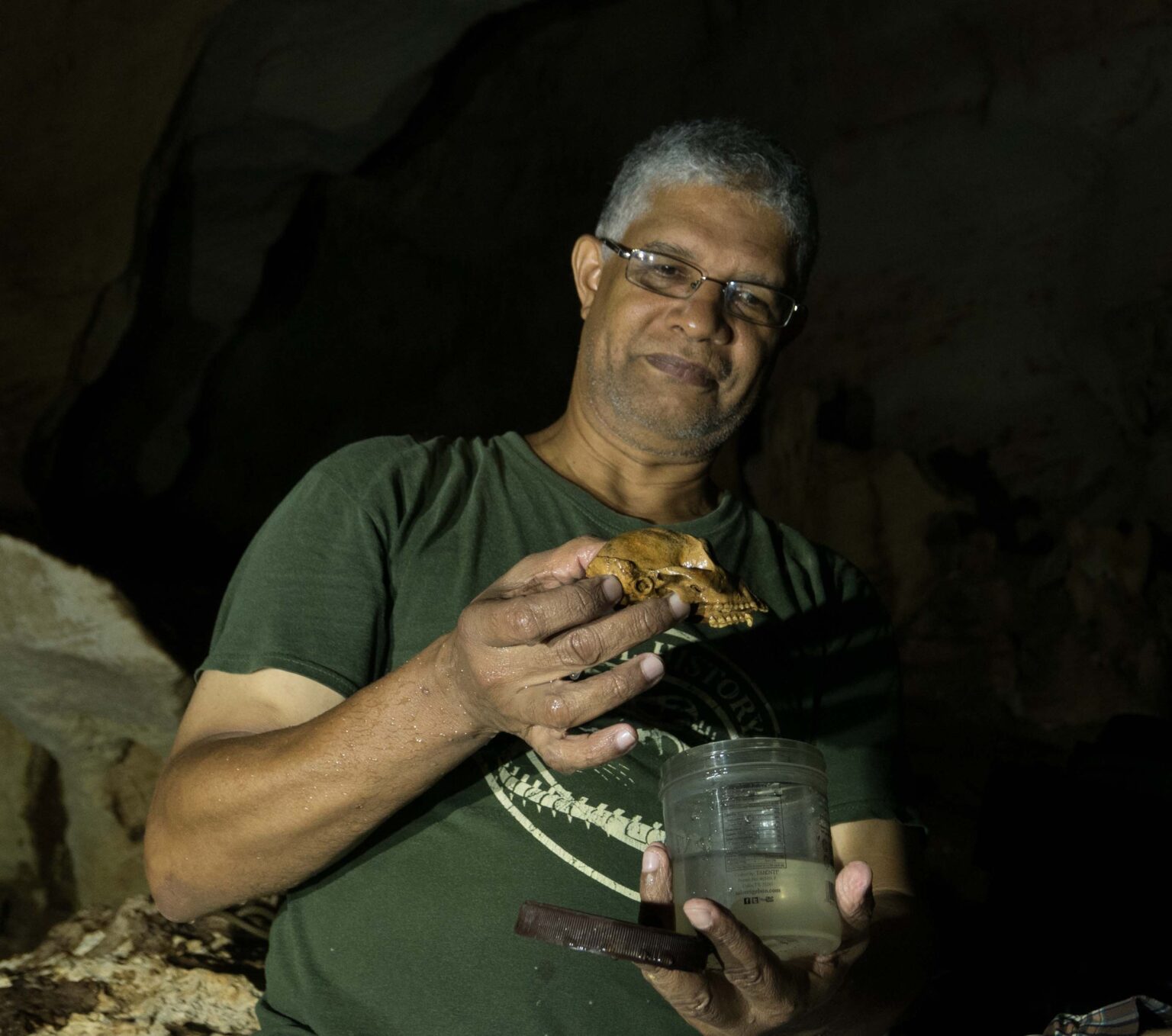 Juan Almonte-Milan inspects one of the new crania found within Cueva Macho. (Phillip Lehman)