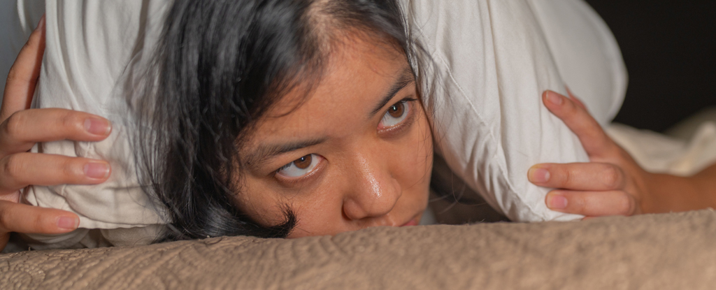 Women holding pillow over ears