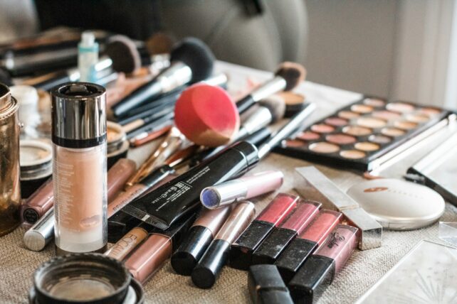 Pile of make up products splayed across a surface