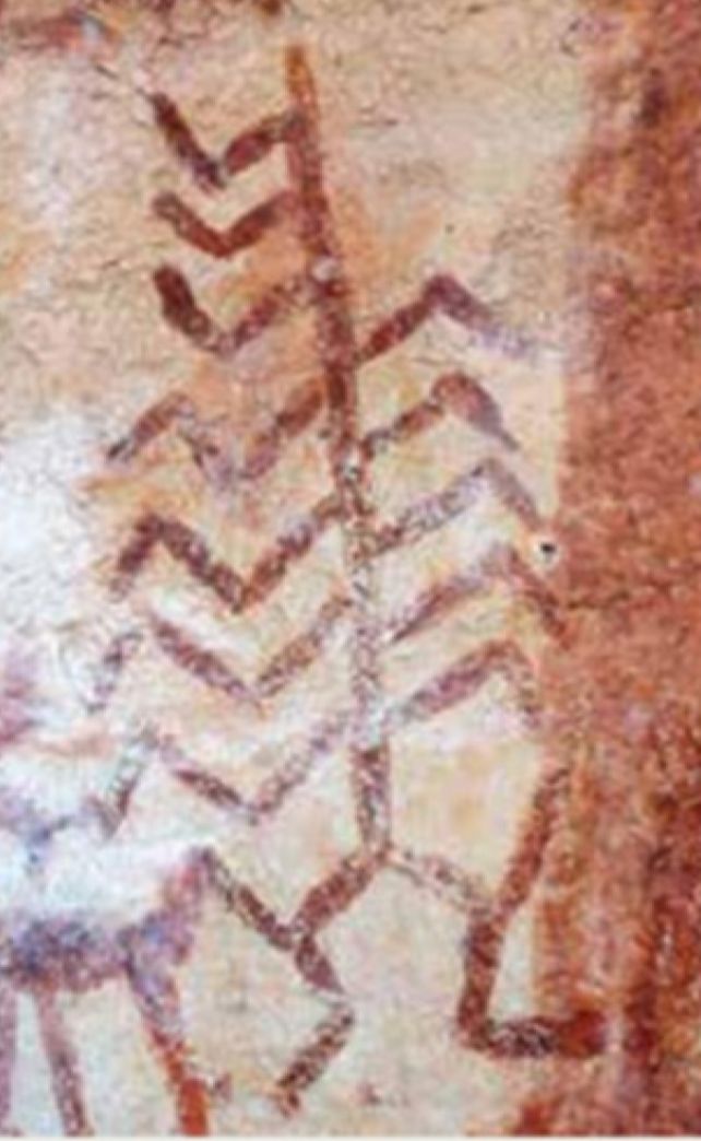 A fern like ochre rock painting motif with human like legs