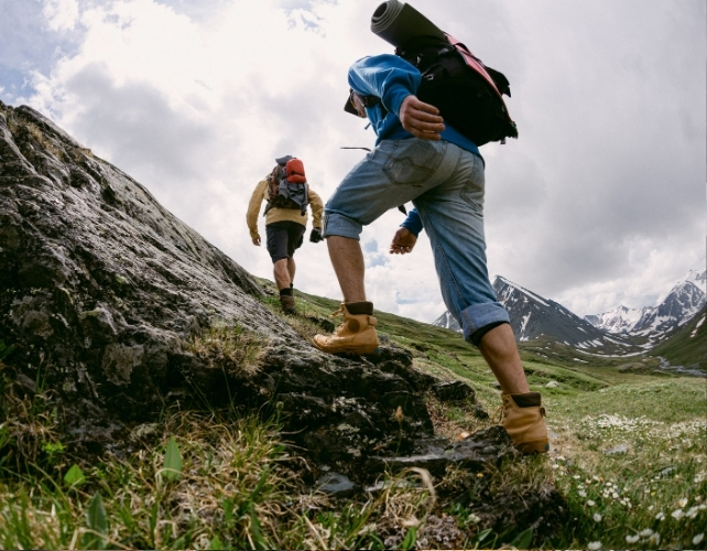 People carrying gear up a hill