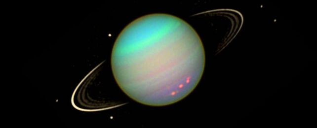 Uranus and its moons in colorful hues