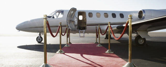 private jet with red carpet leading to the front door