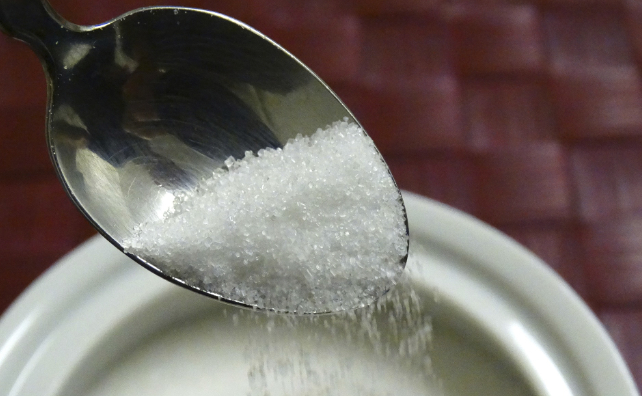 sugar pouring from a teaspoon