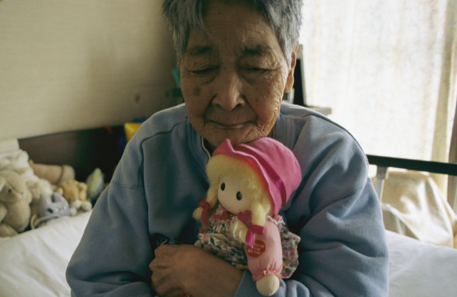 woman cradling a cloth doll