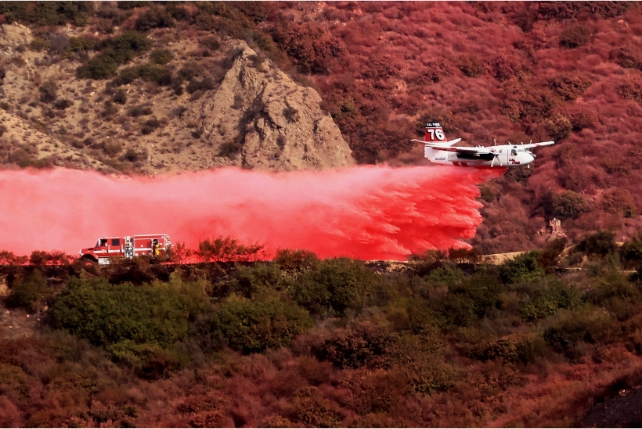 A plane spraying flame retardant