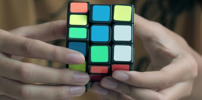 Hands holding a Rubik's cube