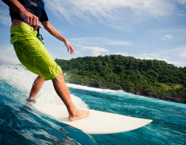 A person's lower body visible on a surfboard