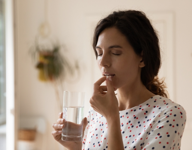 A women takes a pill 