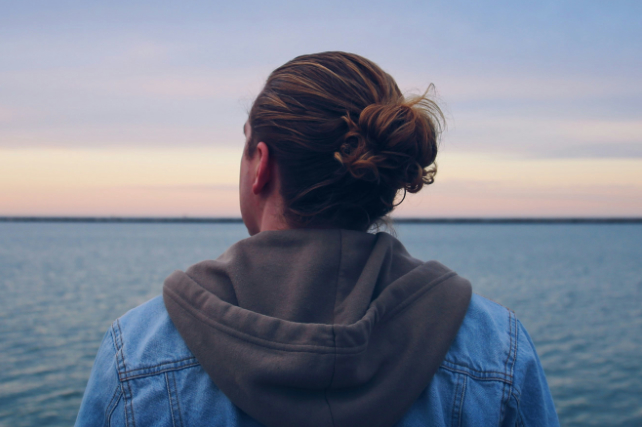 person from behind, looking at the ocean