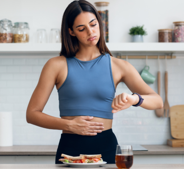 woman looking at her watch before eating