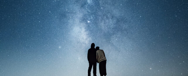 milky way in the sky over two people