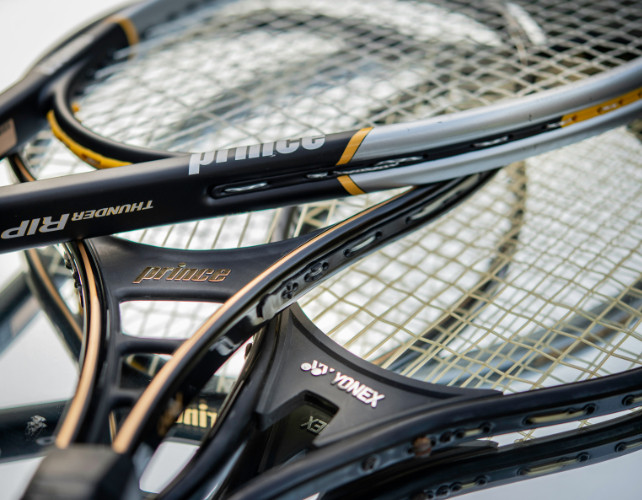 pile of modern tennis rackets