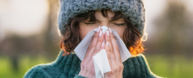 woman blowing her nose