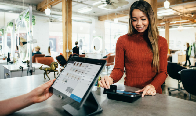 woman paying at the counter