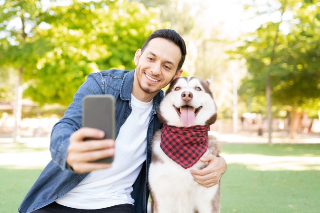 Dog and human taking a selfie outdoors