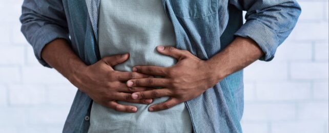 Man clutching at his stomach with both hands