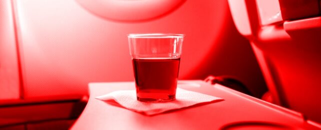 Red Drink On Plane Tray