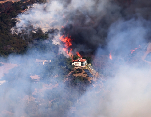 A burning house with lots of wind