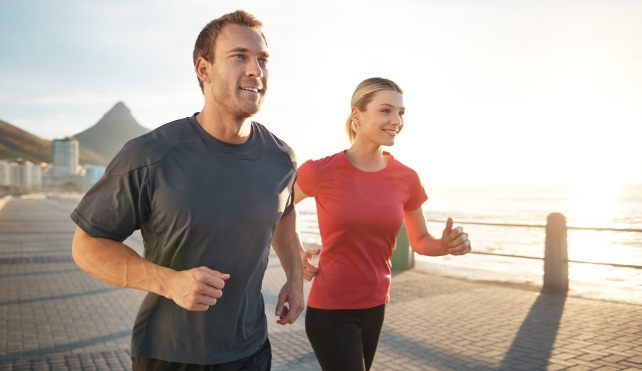 A young couple running outdoors