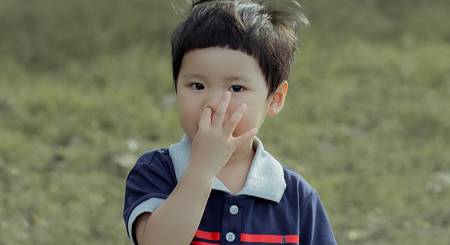 child picking their nose