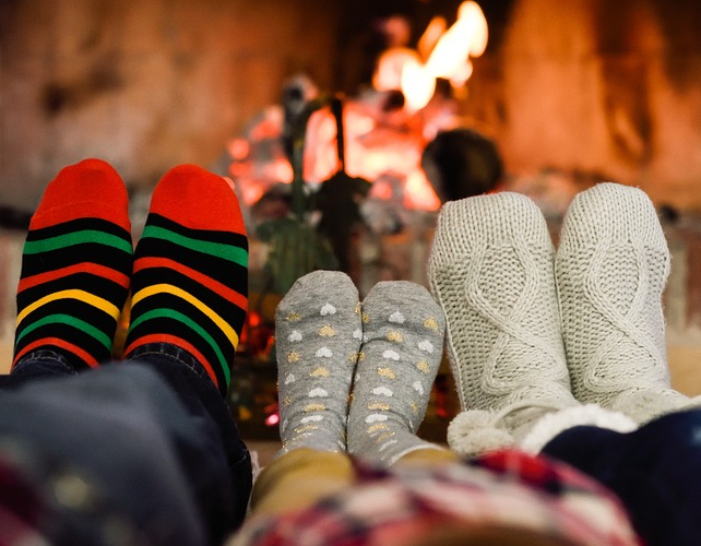 socked feet warming by the fire