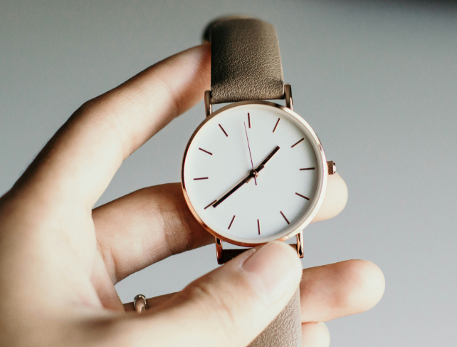 hand holding a watch