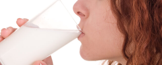 close up of a woman drinking milk from a glass