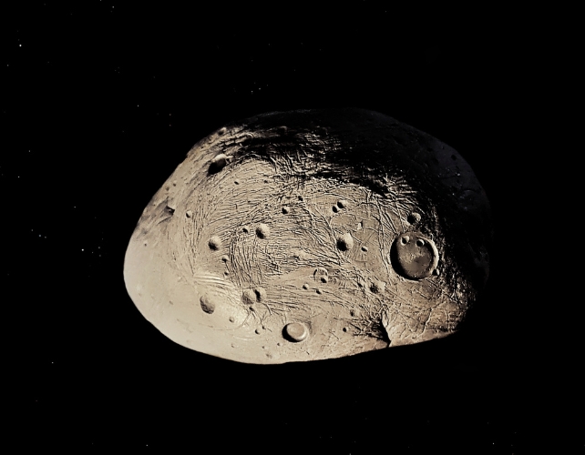 An asteroid with impact craters, on a black background