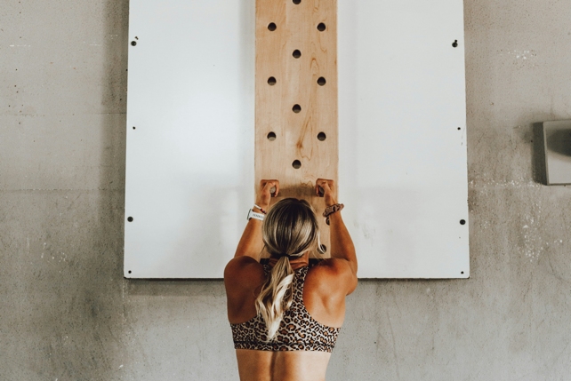 Woman Climbing Wall