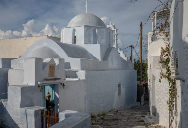 woman stepping out of amorgos house