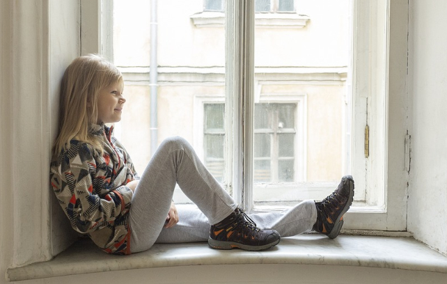 girl sitting near window